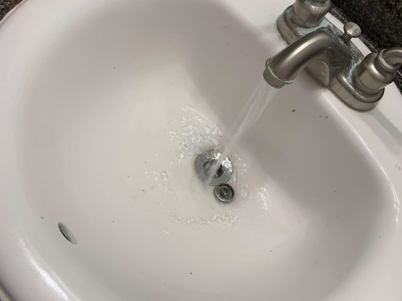 The same sink after resurfacing, clean and white