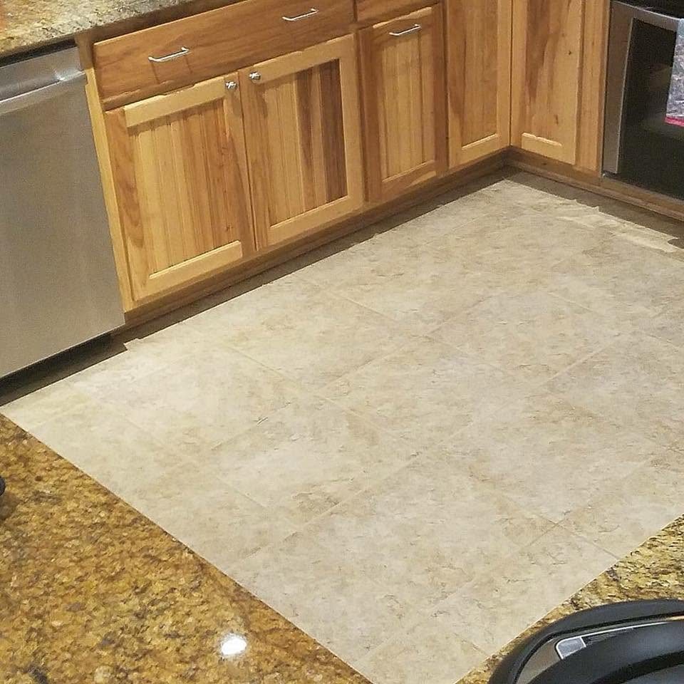 Kitchen tile cleaned between granite counters