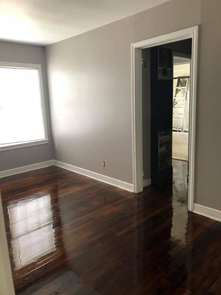 A painted room with gleaming refinished hardwood