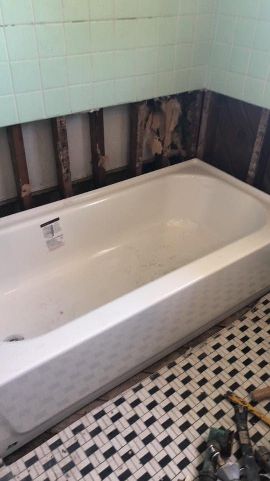 Drywall cut out around a tub for repair