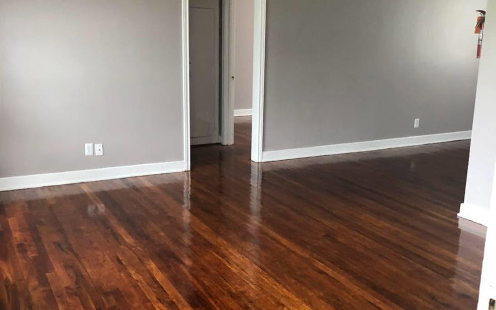 A turned unit with fresh gray paint, white baseboards and refinished hardwood floors
